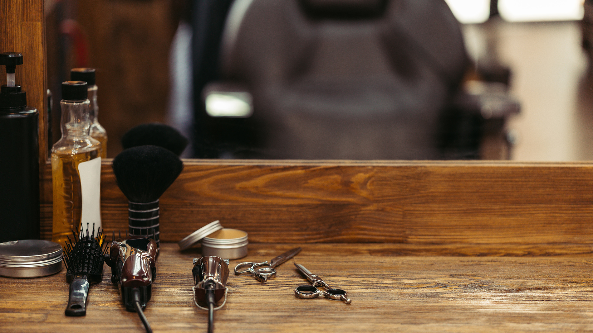 barber tools on wooden shelf and mirror in barbershop