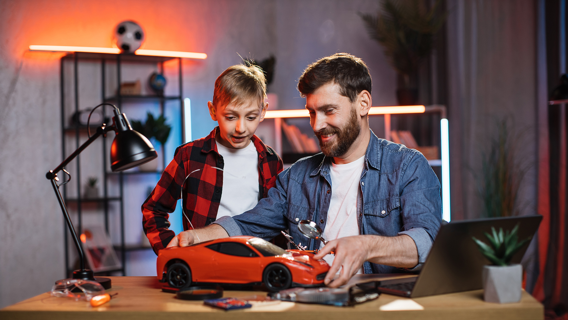 Father with son repaired remote controlled toy car